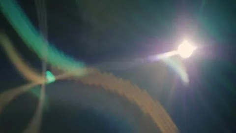 White spotlight generates color highlights on a black background Stock Footage 313173933