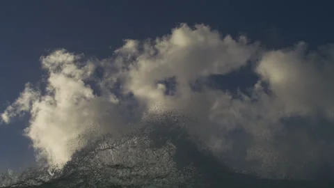 White Spray Erupting From Ocean Wave Beneath Towering Clouds Stock Footage 344382749