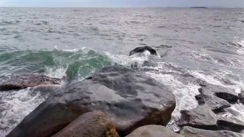 White spray explodes in slow motion against wet stone Stock Footage 312466399