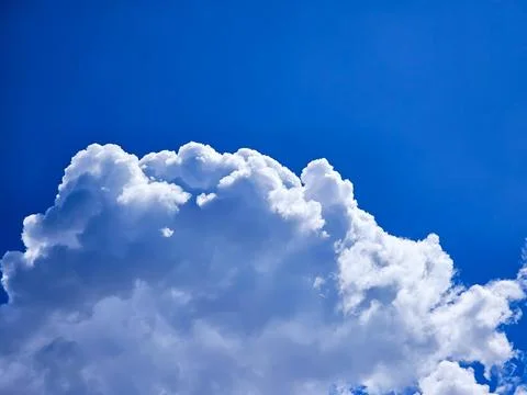 White spring clouds with deep blue background Stock Photos