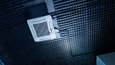 White square air conditioner on the ceiling with grated decor Stock Footage 267904603