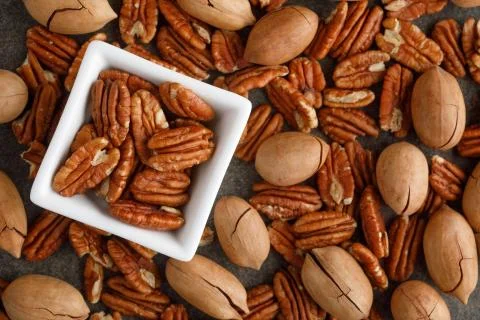 White square bowl of pecan nuts. Healthy eating concept Stock Photos