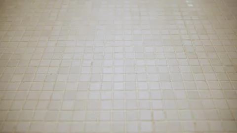 White square mosaic tile pattern with beige grout Stock Photos