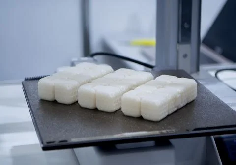 A white square object build surface 3D printer close up. A white plastic model Stock Photos