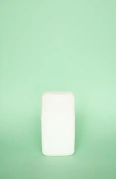 White square shampoo bottle or shower gel on pastel green background. Container Stock Photos