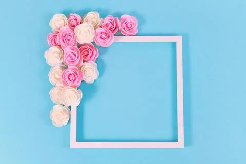 White square shaped picture frame surrounded by pink and white foam rose flower Stock Photos