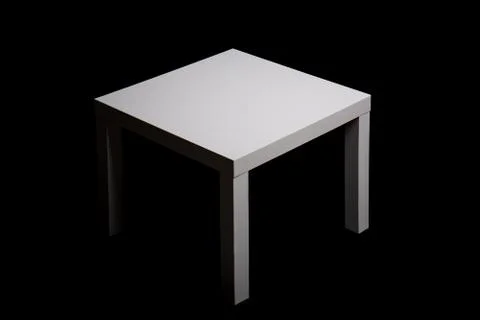 White the square table on a black background Stock Photos