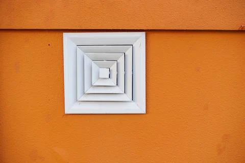 White square vent on orange textured wall Fotos Stock