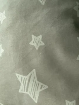 White Star Pattern on Dark Fabric Stock Photos