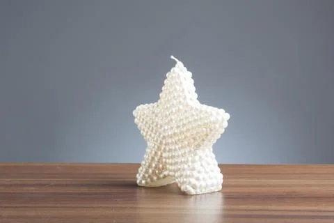 White star shape candle on table Stock Photos