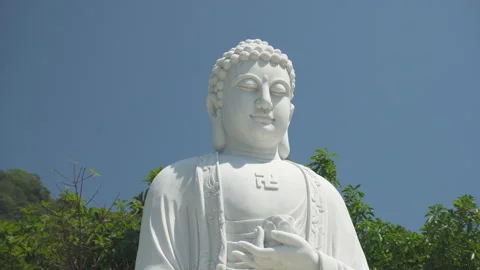 White statue of Buddha on blue sky background Stock Footage 306115017