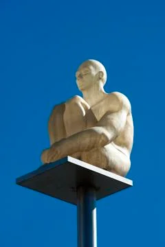 White statue on a pole in the sky Stock Photos