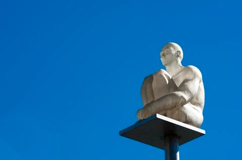White statue on a pole in the sky Stock Photos