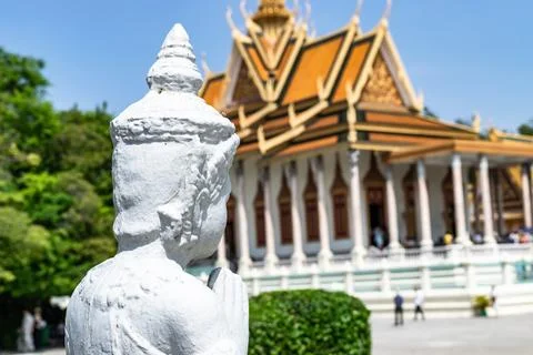 White statue praying in front of silver pagoda, phnom penh, cambodia Stock Photos