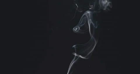  White steam rises light, graceful twists on a black background.  Stock Footage 220387381