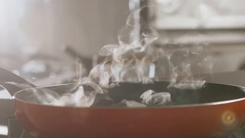 White steam rises in slow motion from a pan Stock Footage 113742563