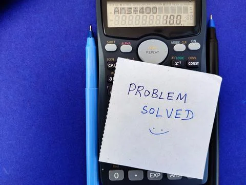 A White sticky note with text PROBLEM SOLVED on top of Scientific calculator Stock Photos