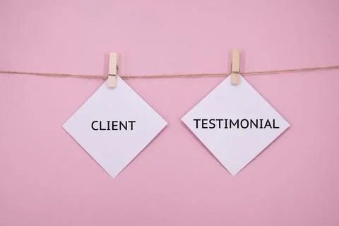 White sticky note with the word CLIENT TESTIMONIAL on PINK background Stock Photos