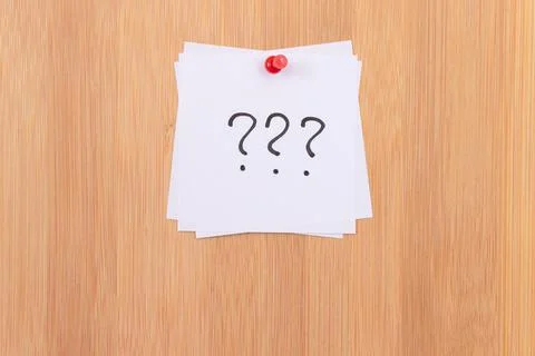 White Sticky Notes with Three Question Marks Pinned to the Wooden Message Board Stock Photos