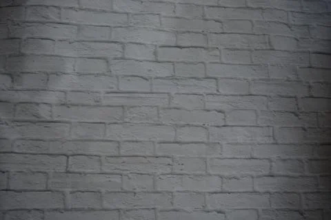 White stone background of light bricks covered with layer of white paint texture Foto stock