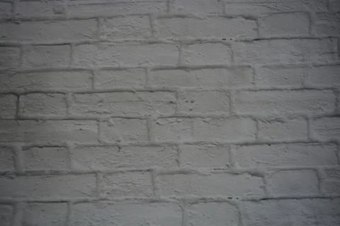 White stone background of light bricks covered with layer of white paint texture Foto stock