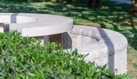 White stone bench in a summer park Stock Photos
