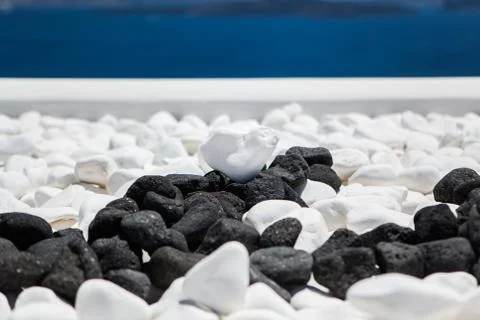 White stone heart shape on a background of blue sea and sky Stock Photos