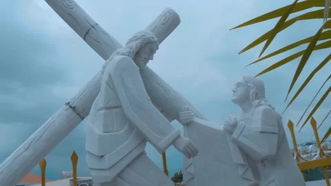 A white stone or marble sculpture depicting Jesus Christ carrying the cross  Stock Footage 340631118