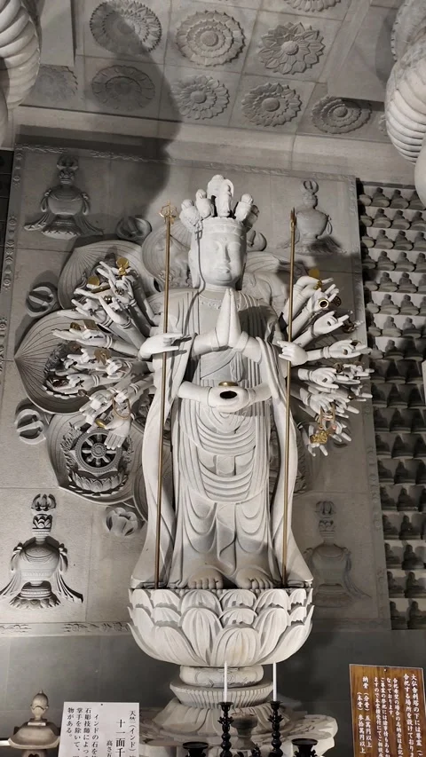 White Stone Statue of Multi-Armed Deity in Intricate Temple Interior Stock Footage 327487448