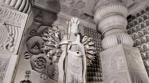 White Stone Statue of Multi-Armed Deity in Intricate Temple Interior Stock Footage 327487559