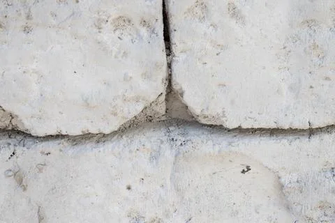 White stone wall texture with rough rocky masonry Stock Photos