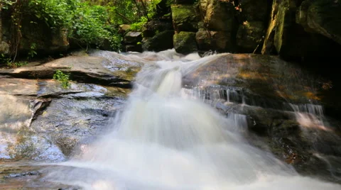 White streams flowing from the waterfall Stock Footage 68669248