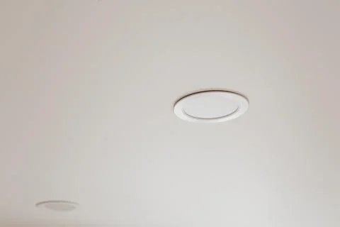 White stretch ceiling with spot lights in room Stock Photos