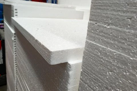 White Styrofoam sheets stacked in a warehouse showing texture and edges on a Photos