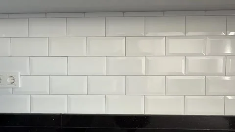 White subway tile kitchen wall with electrical outlet serves as modern inte.. Stock Footage 331090346