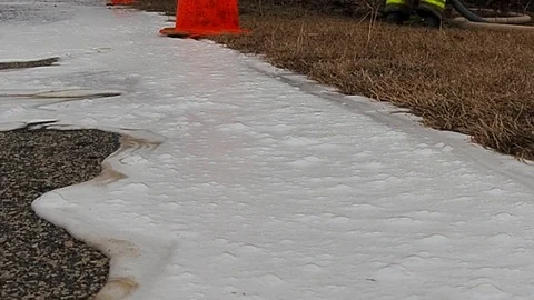 White suds flowing down side of road Stock Footage 73433053