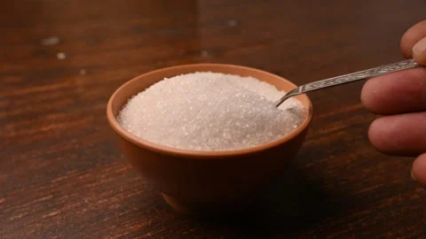 White Sugar Being Scooped with Spoon from Bowl  Soft Blur Background Stock Footage 334641449