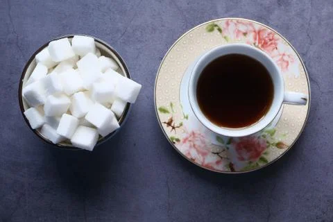 White sugar cube in a bow and coffee on desk Stock Photos