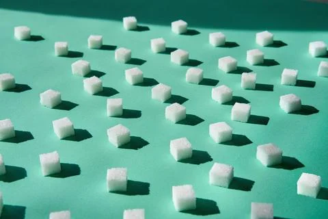 White sugar cubes with hard sunlight shadows Stock Photos