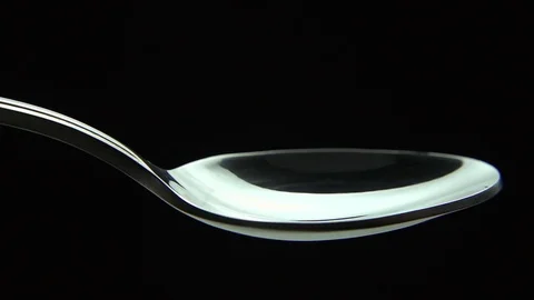White sugar fall down into a spoon Stock Footage 83038944