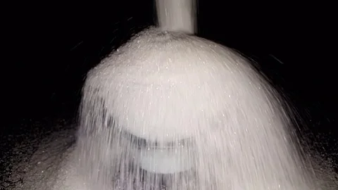 White Sugar falling against Black Background, Slow Motion Stock Footage 83876985