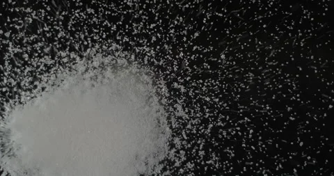White sugar falling from below, slowmotion low angle 4K pro res Stock Footage 275898138