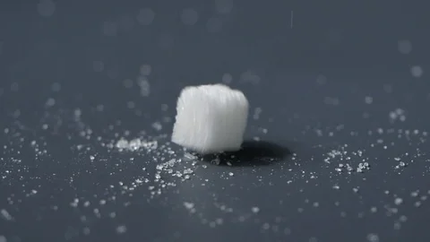 White sugar falling in slow motion on black background Stock Footage 113595451