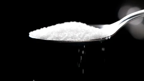 White sugar falling in slow motion on black background Stock Footage 113596471