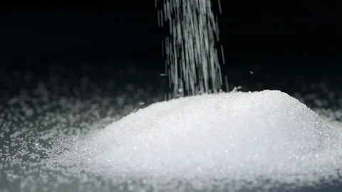 White sugar falling in slow motion on black background Stock Footage 115142816