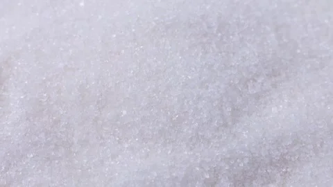 White sugar grains falling down close up Stock Footage 243560444