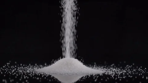 White sugar poured on black background Stock Footage 81180077