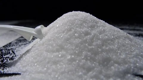 White sugar poured on a table on a black background Stock Footage 147088114