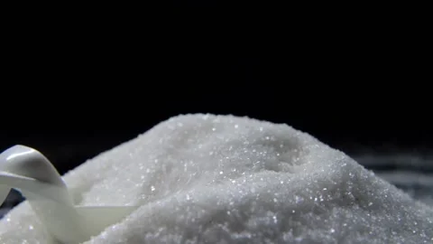White sugar poured on a table on a black background Stock Footage 147088118