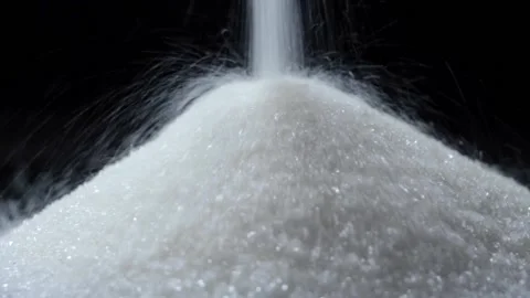 White sugar poured on a table on a black background Stock Footage 147088121